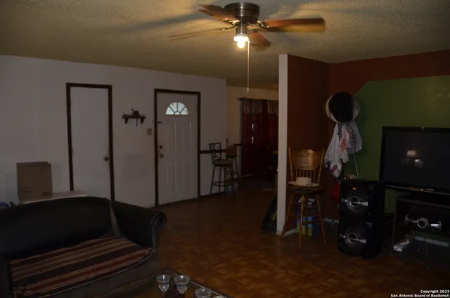 a view of a hallway with entryway and hall with wooden floor
