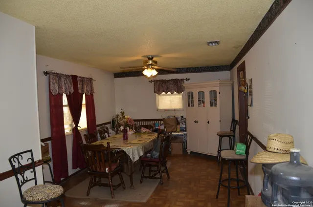 a dining room with furniture and window