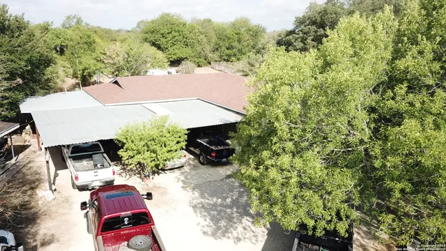 an outdoor space with furniture and red umbrella