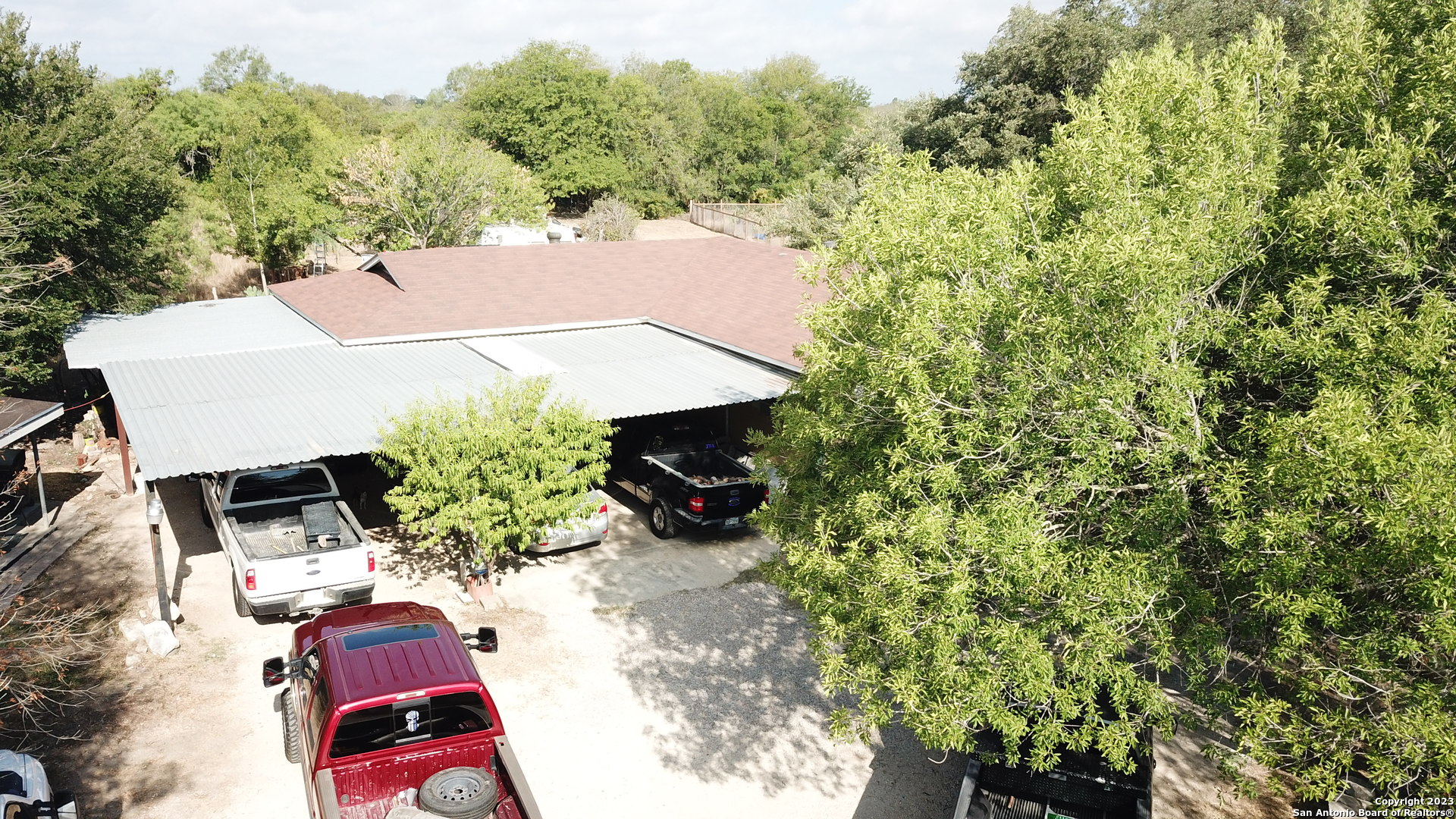 10805 Hollowell Road Atascosa, TX 78002 - Photo 22 of 25 an outdoor space with furniture and red umbrella
