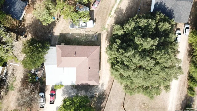 an aerial view of a house with a yard
