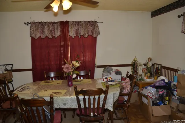 a view of a dining room with furniture and chandelier