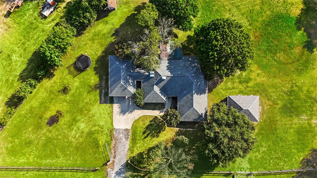11005 Cowboy Lane Flower Mound, TX 76262 - Photo 1 of 14 an aerial view of a house with swimming pool and large trees