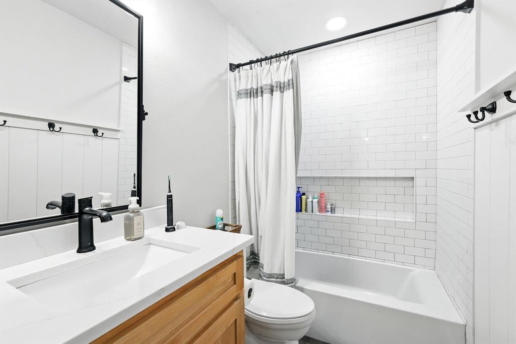 11005 Cowboy Lane Flower Mound, TX 76262 - Photo 10 of 14 a bathroom with a sink a toilet and shower
