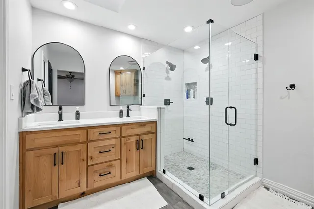 a bathroom with a sink a toilet and shower