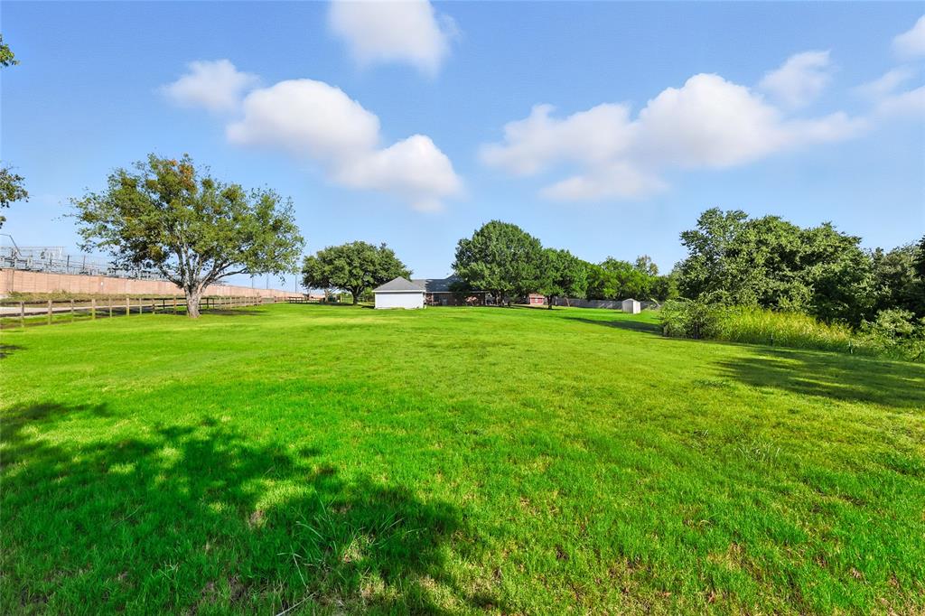 11005 Cowboy Lane Flower Mound, TX 76262 - Photo 2 of 14 a view of a big yard with plants and large trees