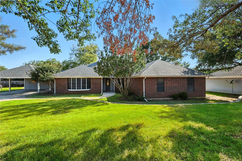 11005 Cowboy Lane Flower Mound, TX 76262 - Photo 6 of 14 a front view of a house with a garden