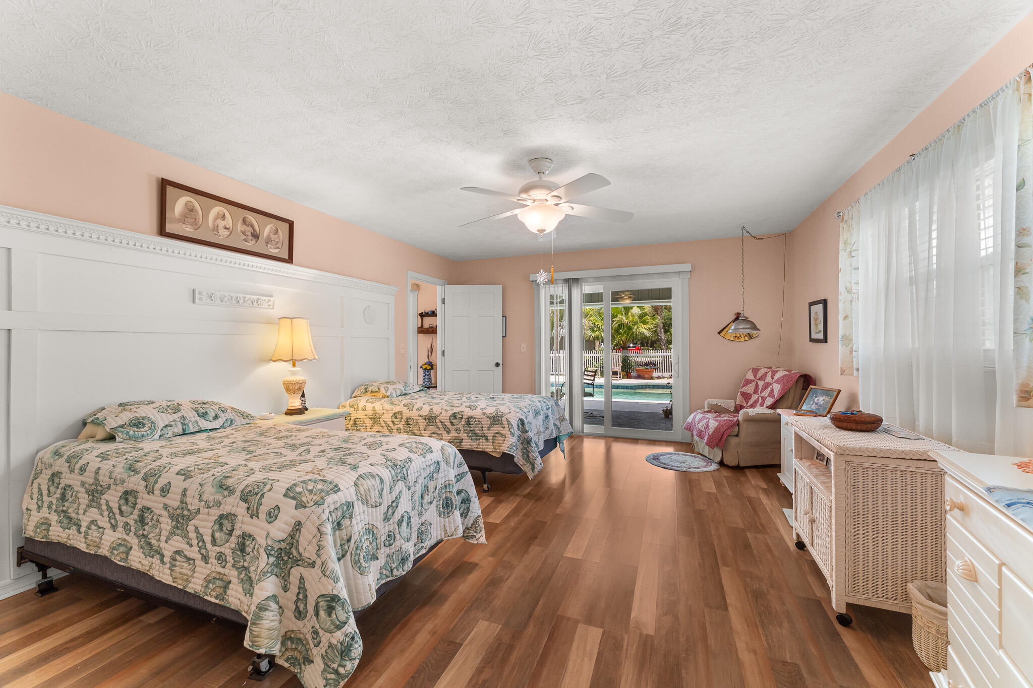 1653 Southwest 85th Terrace Stuart, FL 34997 - Photo 29 of 54 a bedroom with a bed and wooden floor