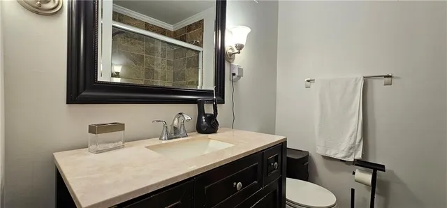 a bathroom with a sink a toilet and mirror