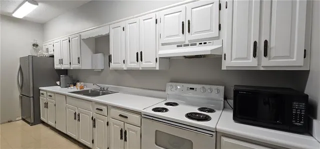 a kitchen with stainless steel appliances white cabinets and a stove