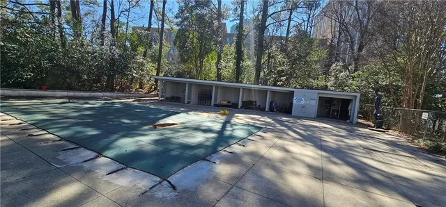 a view of a house with backyard and trees