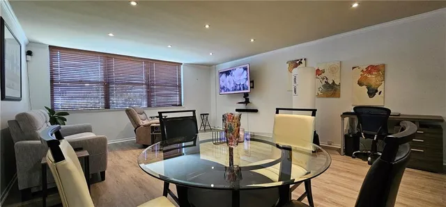 a work room with furniture and a flat screen tv