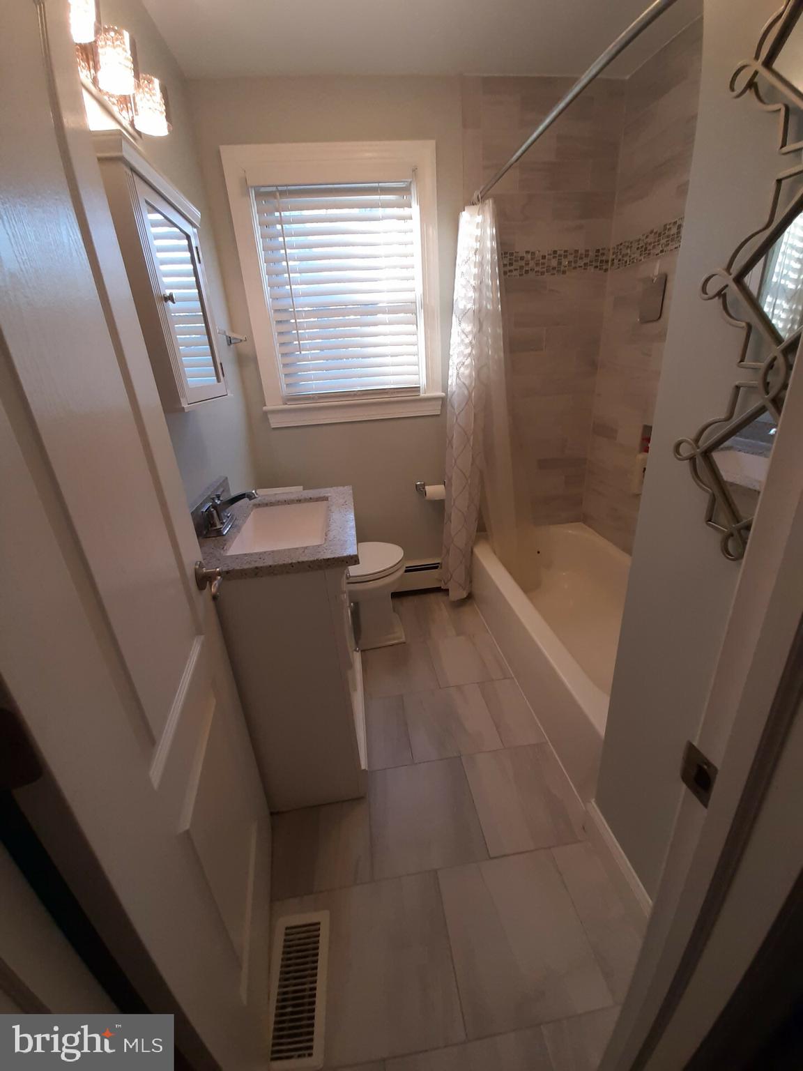 643 Etra Road East Windsor, NJ 08520 - Photo 14 of 26 a bathroom with a tub sink and window