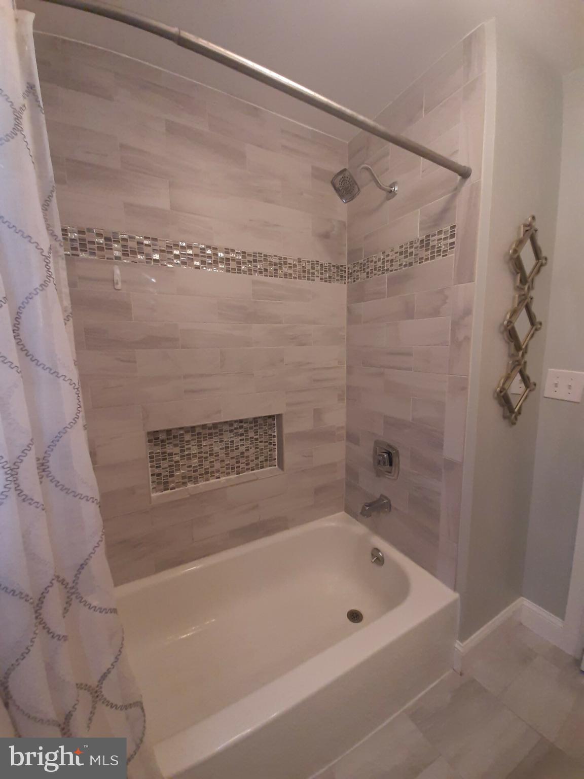 643 Etra Road East Windsor, NJ 08520 - Photo 15 of 26 a bathroom with a shower and a bath tub