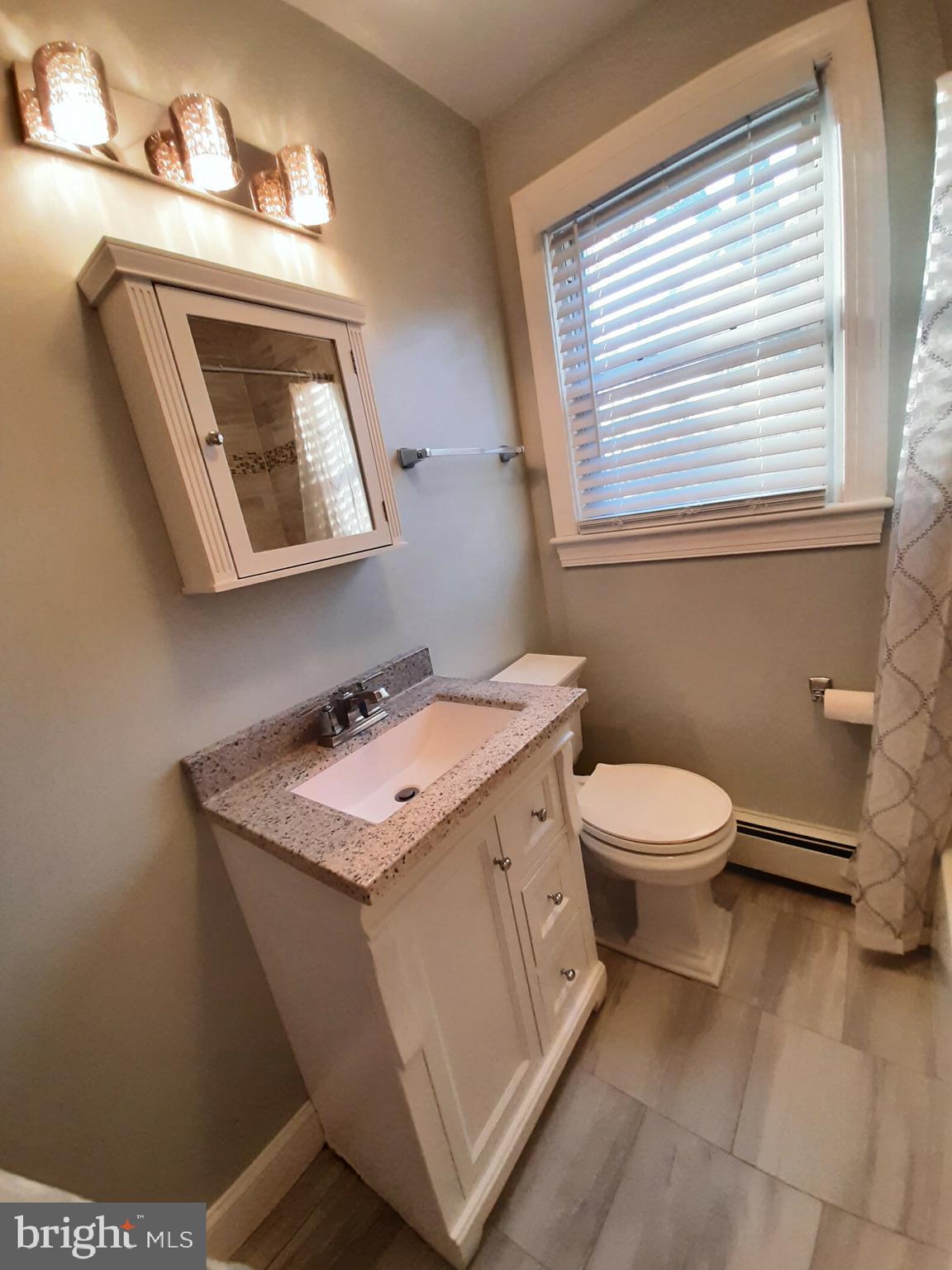 643 Etra Road East Windsor, NJ 08520 - Photo 16 of 26 a bathroom with a toilet sink and mirror