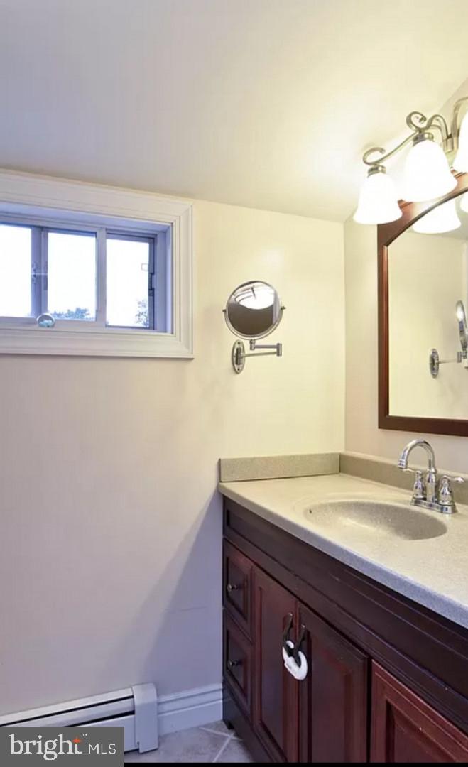 643 Etra Road East Windsor, NJ 08520 - Photo 21 of 26 a bathroom with a sink a mirror and vanity