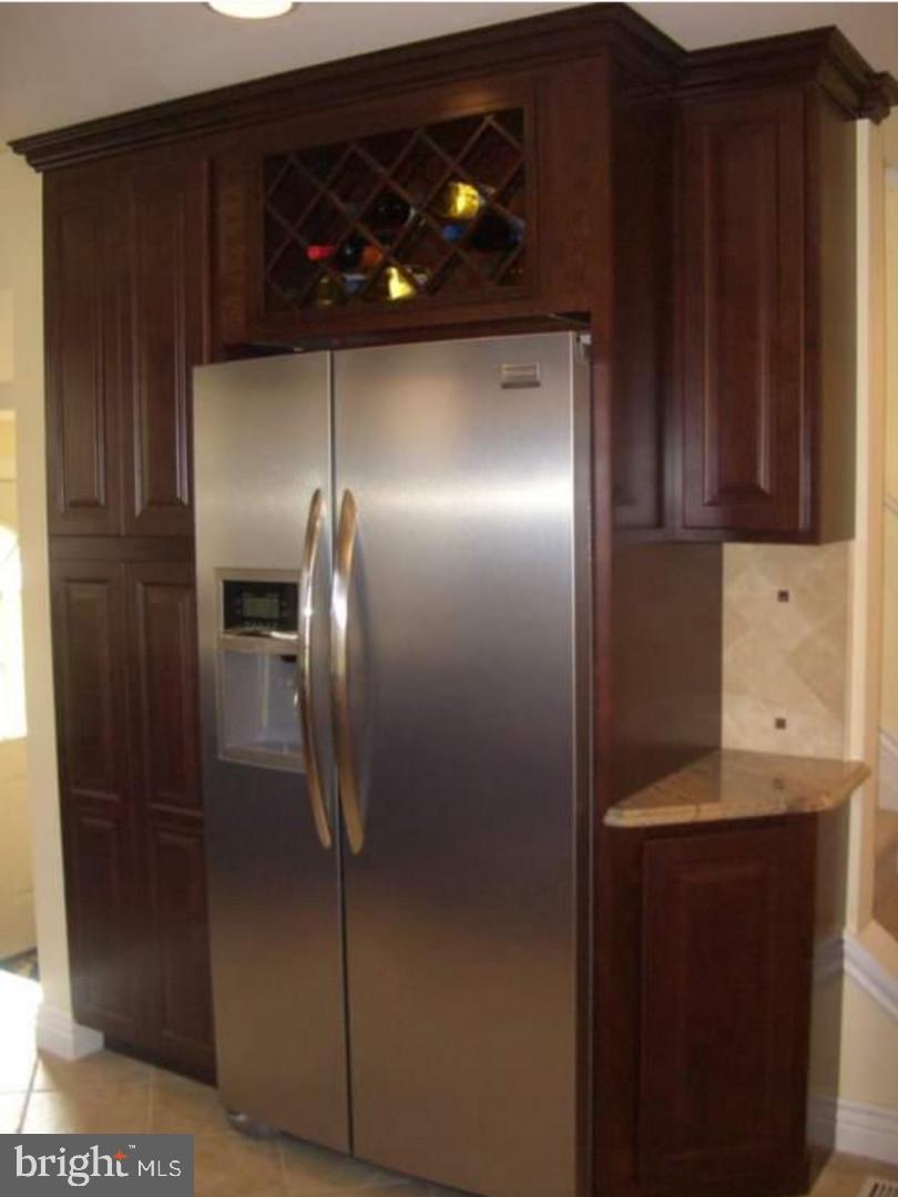 643 Etra Road East Windsor, NJ 08520 - Photo 4 of 26 a kitchen with a refrigerator and cabinets