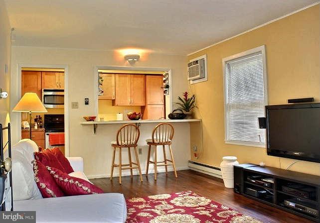 54 Ridge Road, Unit B Greenbelt, MD 20770 - Photo 2 of 9 a living room with furniture and a flat screen tv