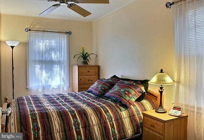 54 Ridge Road, Unit B Greenbelt, MD 20770 - Photo 5 of 9 a bedroom with a bed and a chandelier