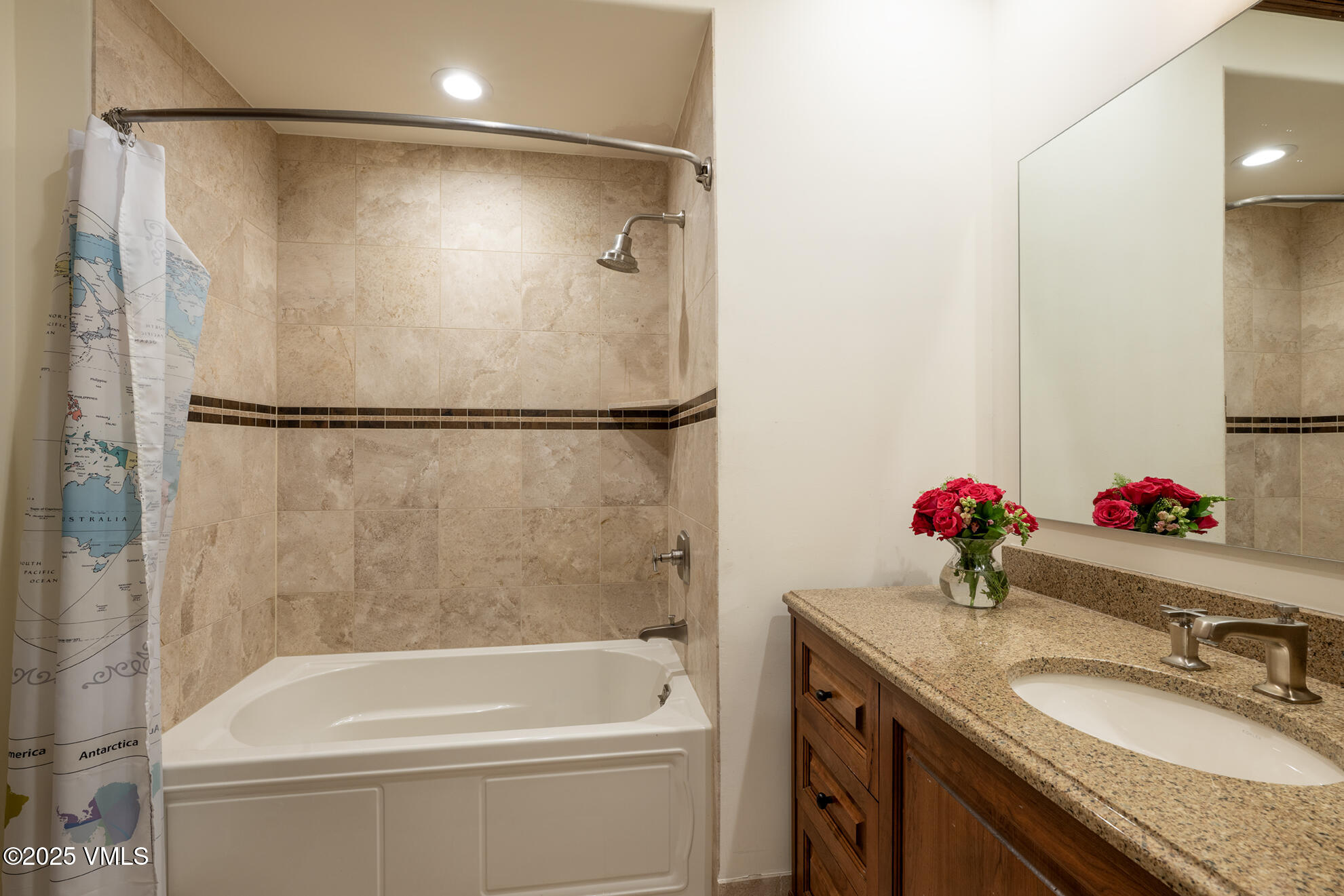 185 Forest Road Vail, CO 81657 - Photo 12 of 13 a bathroom with a granite countertop sink a mirror and a bathtub