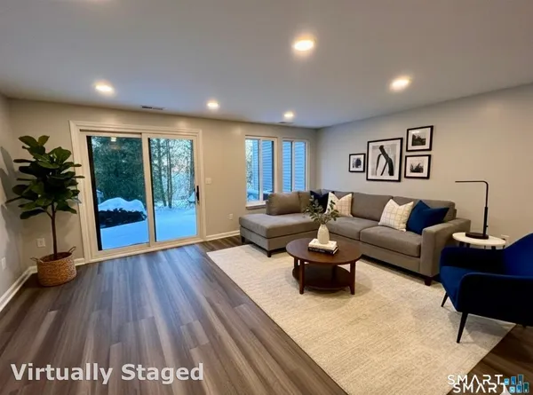 a living room with furniture and wooden floor