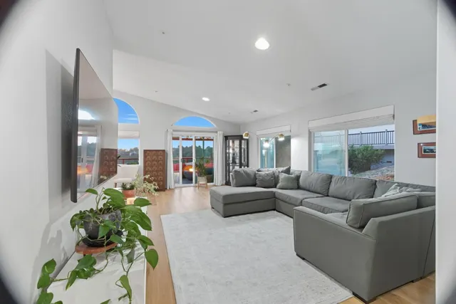a dining room with furniture a chandelier and wooden floor