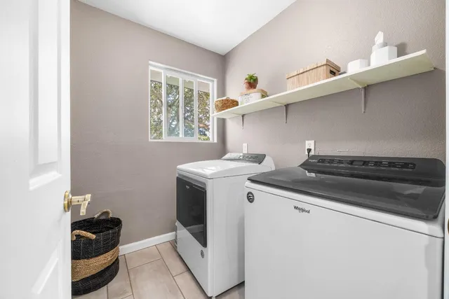 a living room with furniture a window and wooden floor