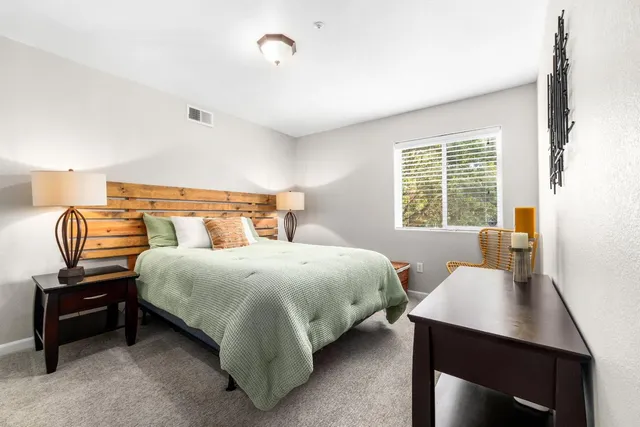 a balcony with wooden floor and potted plants