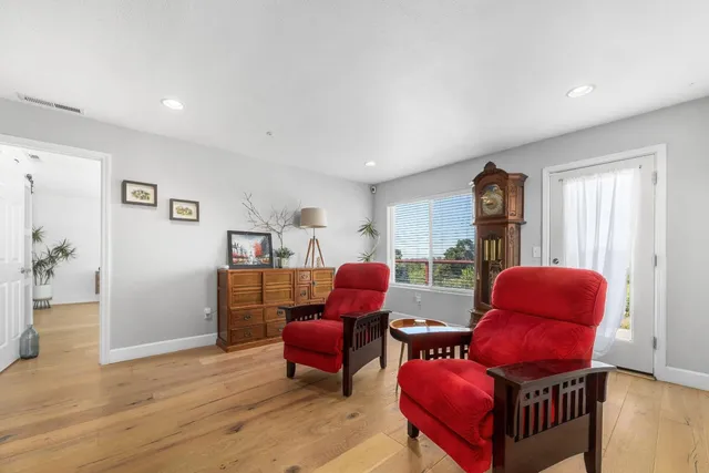 a view of a house with a yard and potted plants