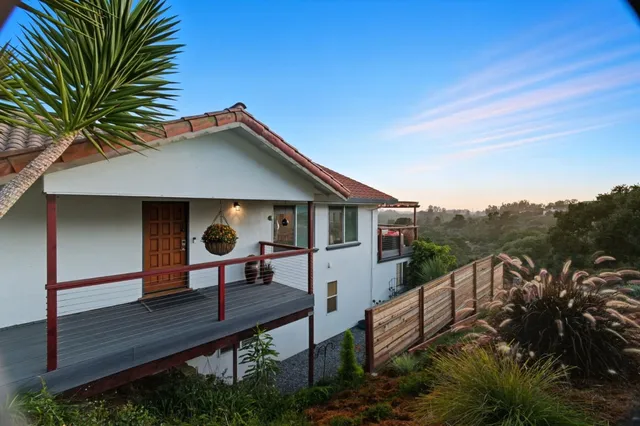 a living room with furniture and flowers