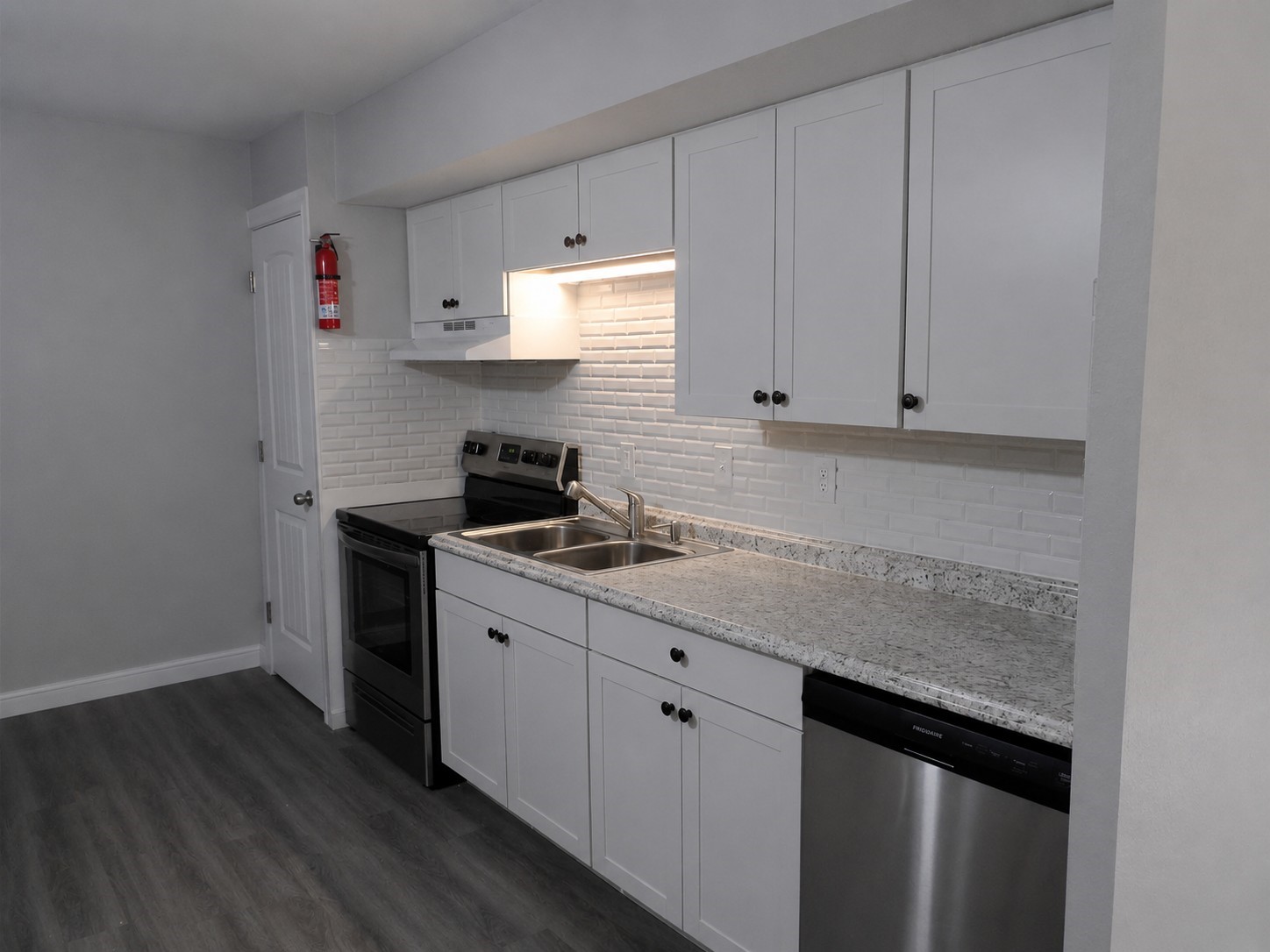 12900 Walden Road, Unit 618F Montgomery, TX 77356 - Photo 4 of 19 a kitchen with granite countertop cabinets and white appliances
