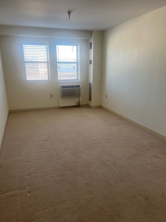 750 Davol Street, Unit 221 Fall River, MA 02720 - Photo 14 of 19 an empty room with windows