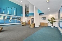 750 Davol Street, Unit 221 Fall River, MA 02720 - Photo 5 of 19 a living room with furniture and a potted plant