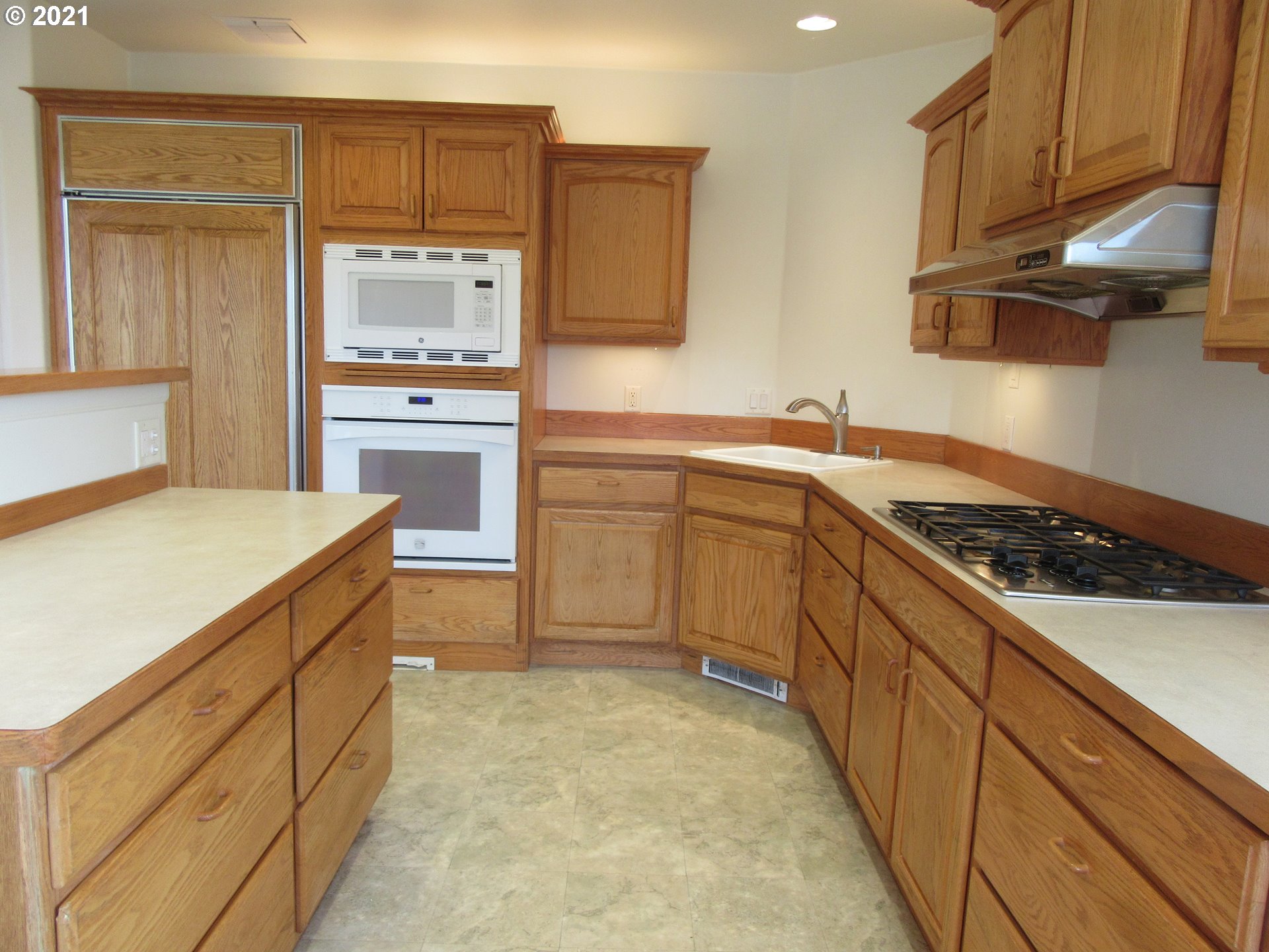 632 West D Street Springfield, OR 97477 - Photo 8 of 24 a kitchen with stainless steel appliances granite countertop a sink and cabinets