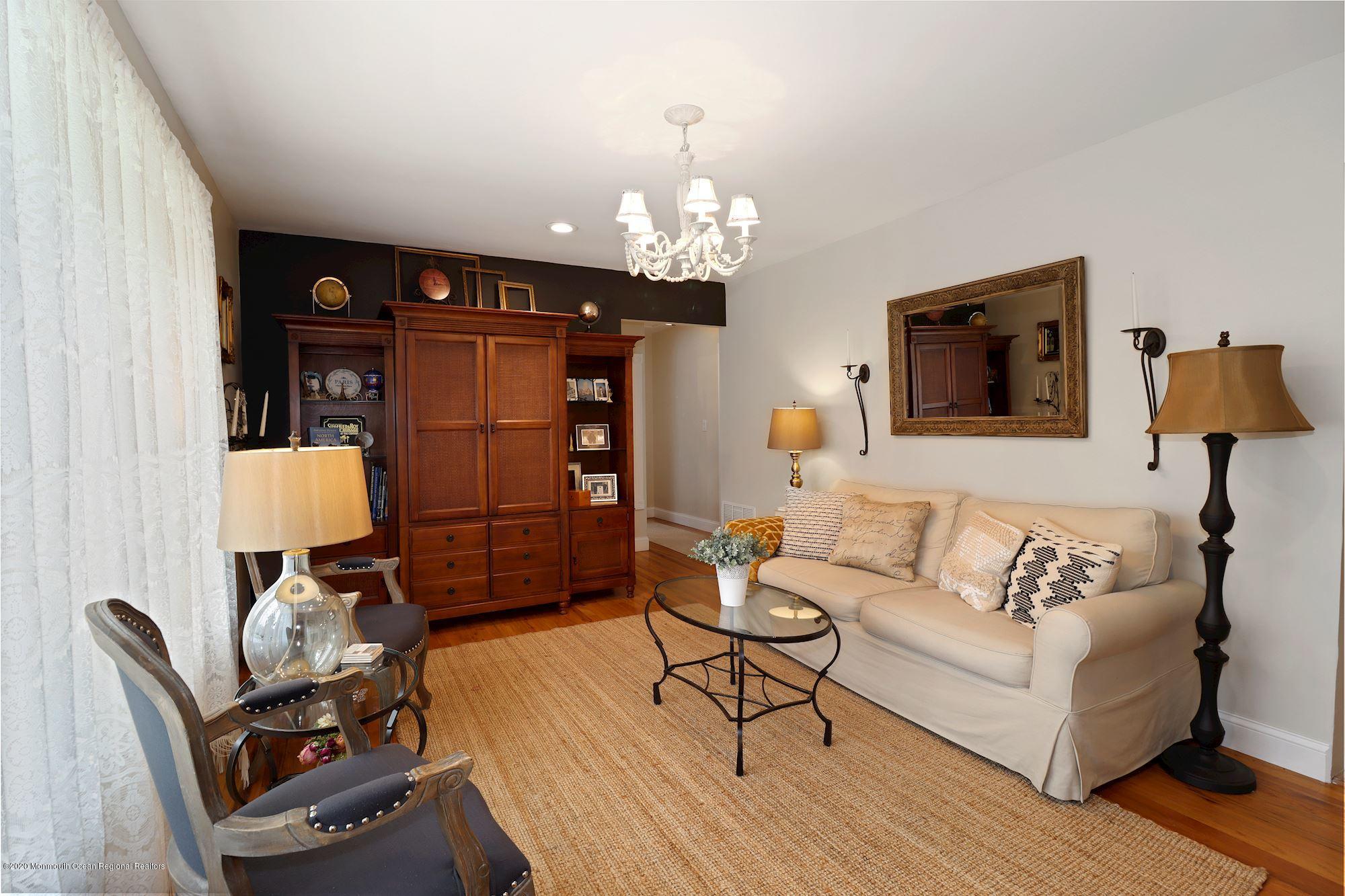 a living room with furniture and a chandelier