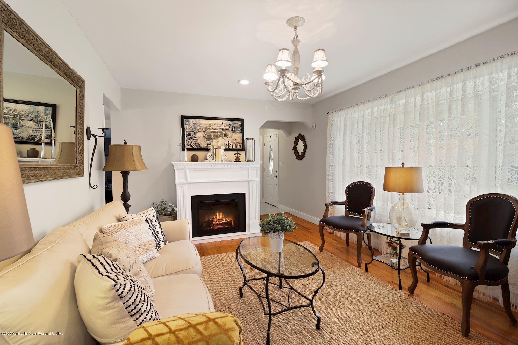 30 Wickatunk Road Manalapan, NJ 07726 - Photo 11 of 31 a living room with furniture and a fireplace