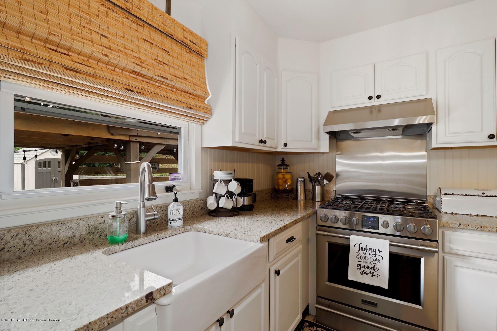 30 Wickatunk Road Manalapan, NJ 07726 - Photo 14 of 31 a kitchen with a stove and white cabinets
