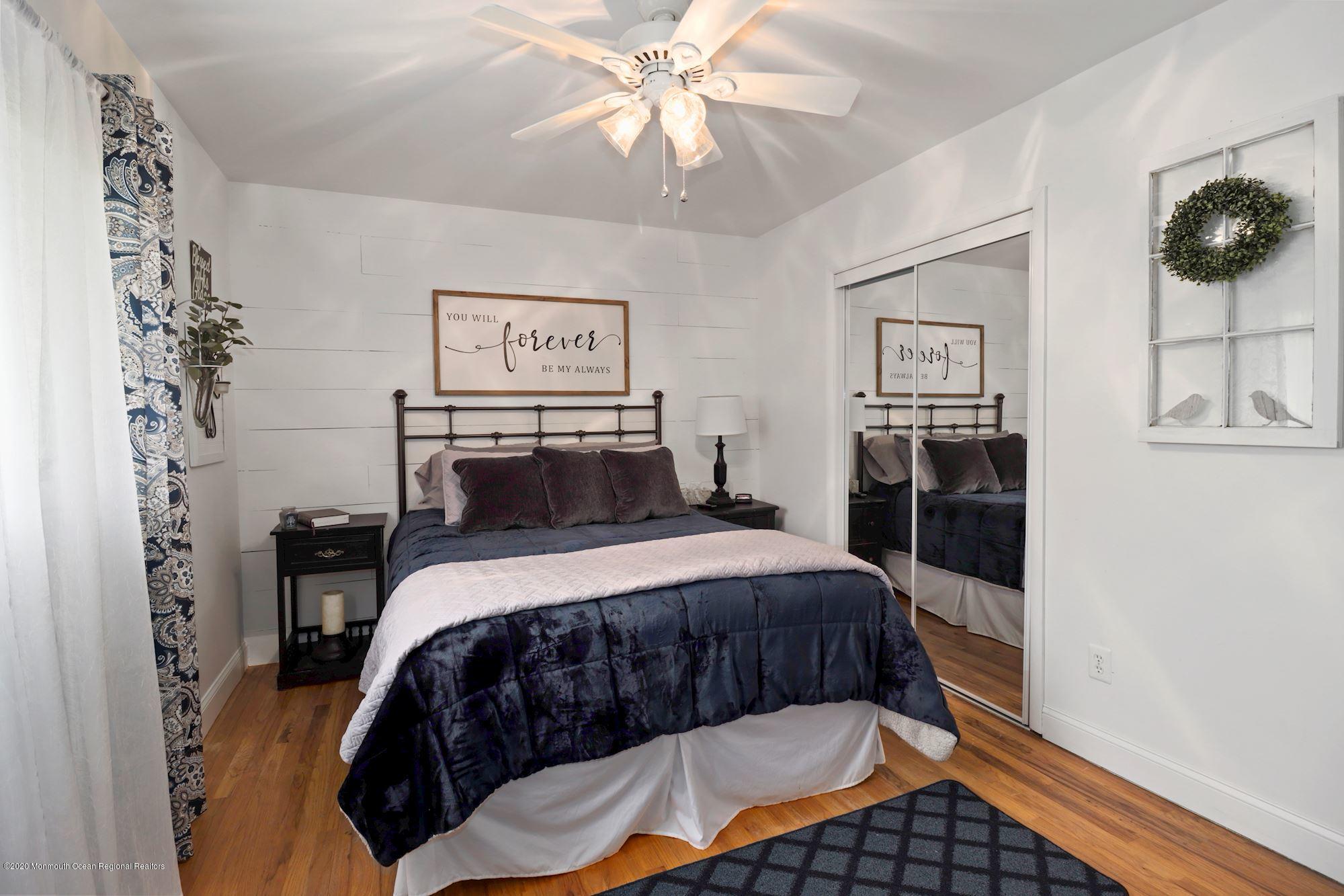 30 Wickatunk Road Manalapan, NJ 07726 - Photo 15 of 31 a bedroom with a bed and cabinets