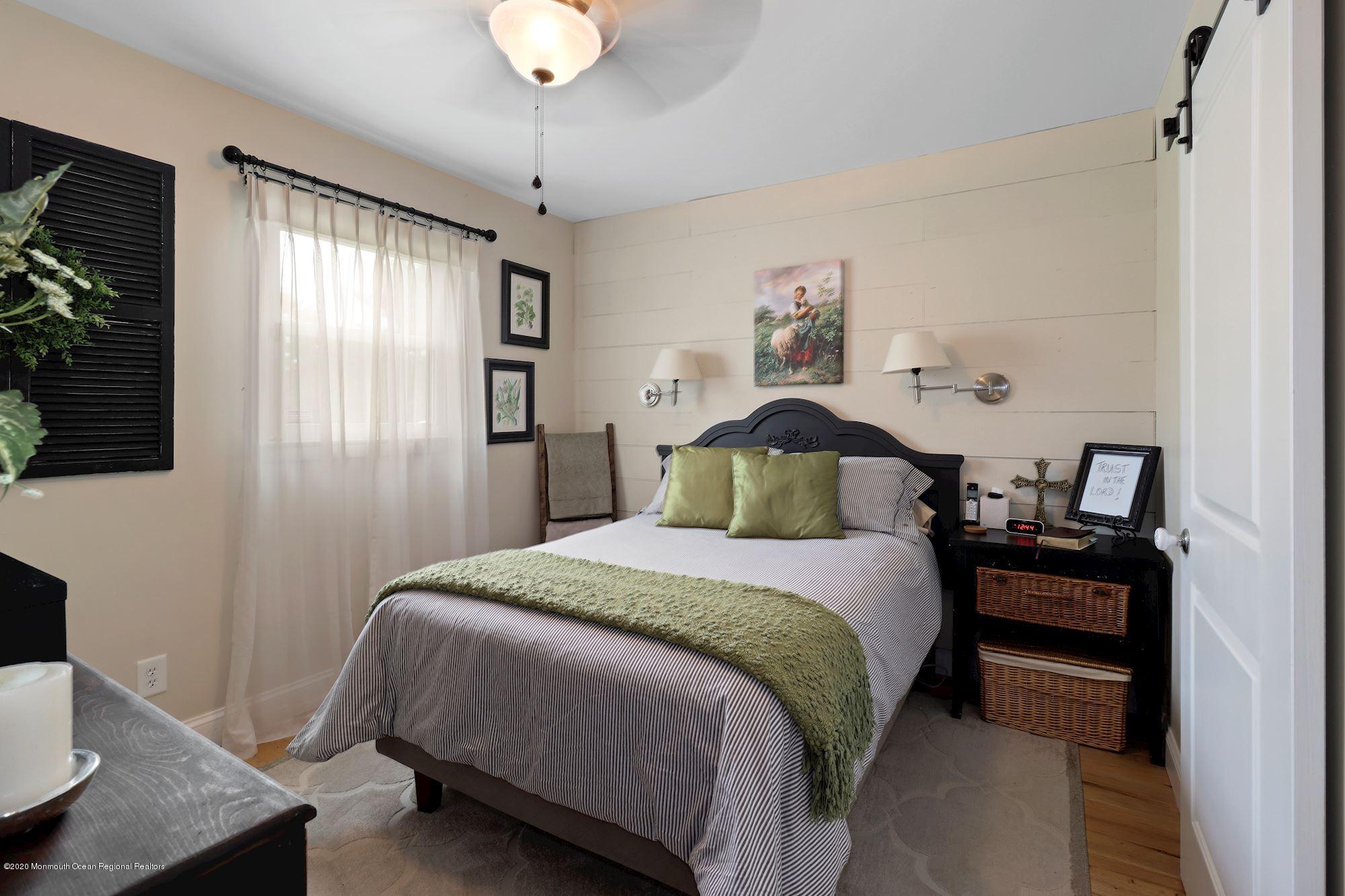 30 Wickatunk Road Manalapan, NJ 07726 - Photo 16 of 31 a bedroom with a bed and wooden floor