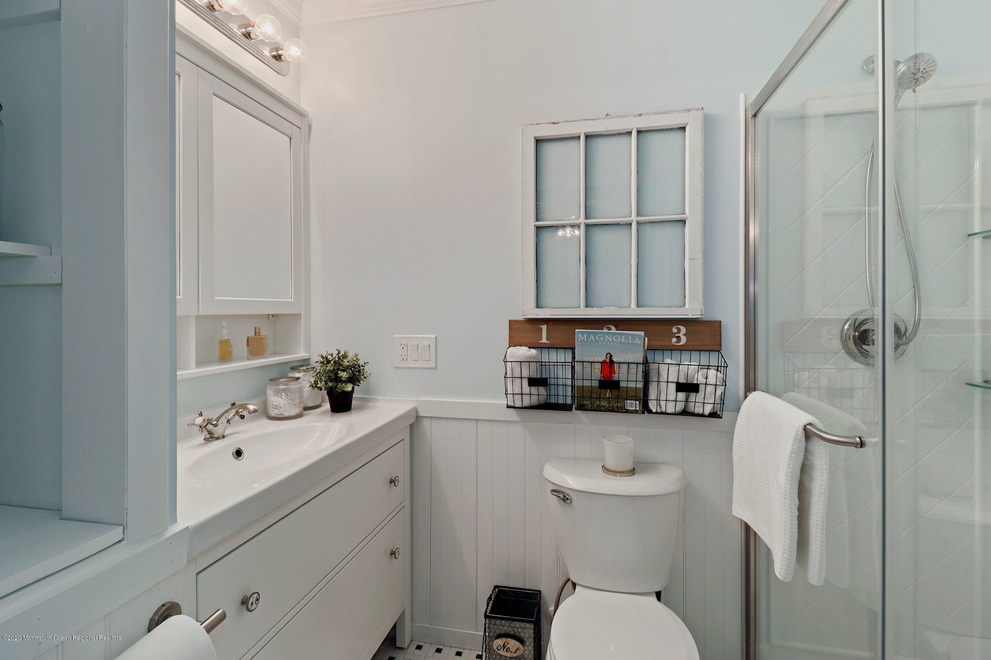 30 Wickatunk Road Manalapan, NJ 07726 - Photo 18 of 31 a bathroom with a sink a toilet and shower