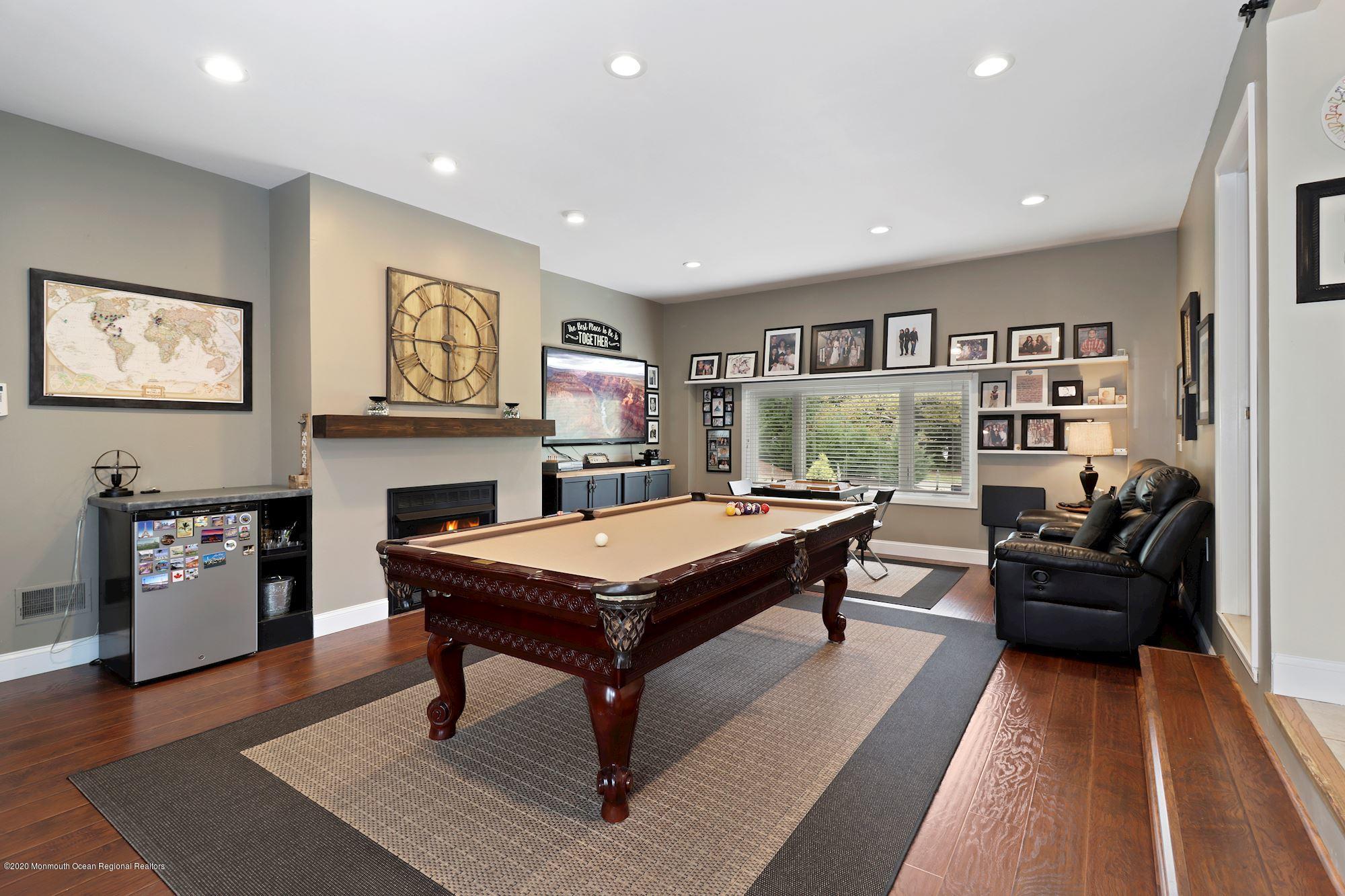 30 Wickatunk Road Manalapan, NJ 07726 - Photo 2 of 31 a living room with furniture and a flat screen tv