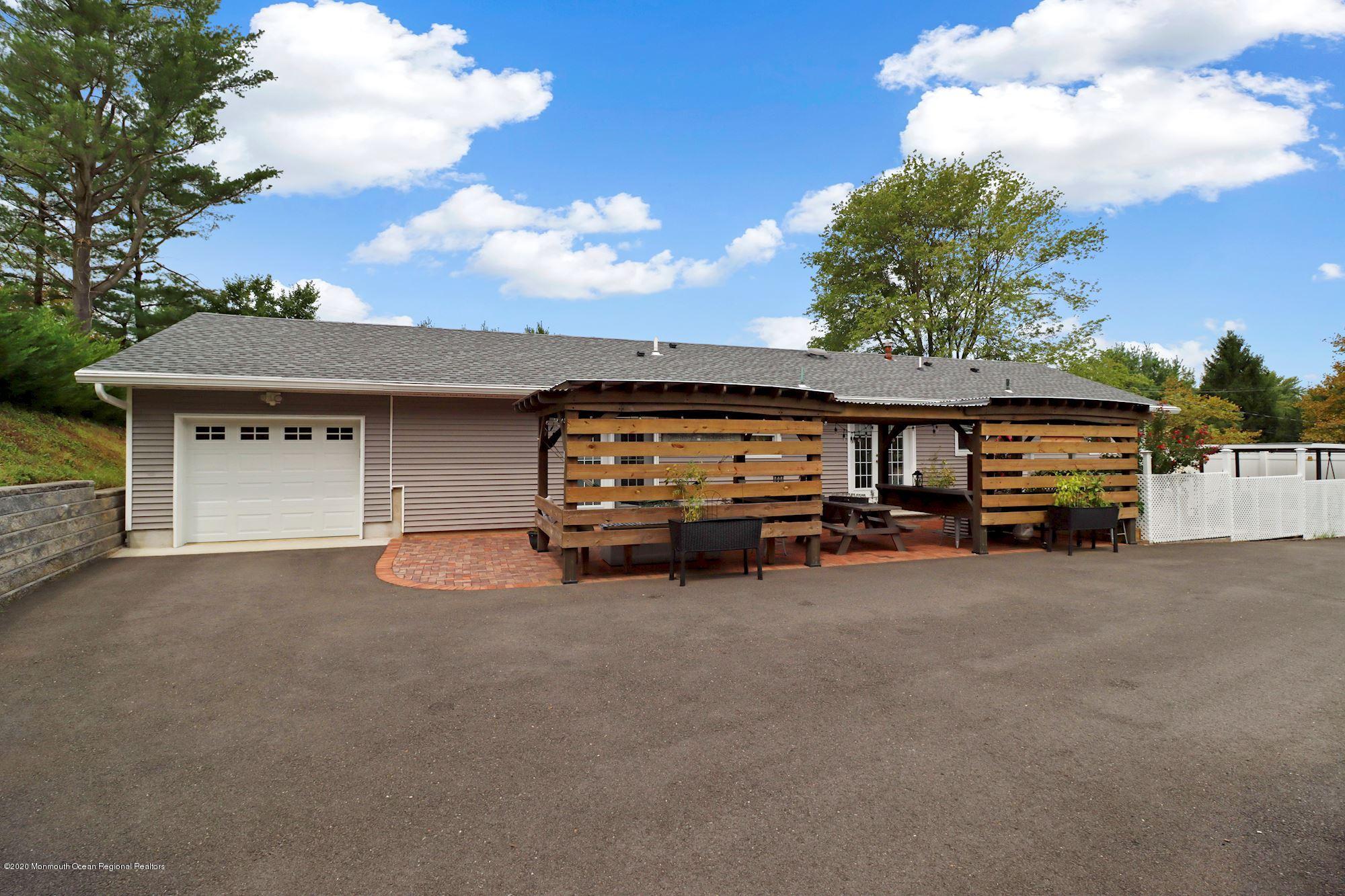 30 Wickatunk Road Manalapan, NJ 07726 - Photo 25 of 31 a view of a car park in front of house