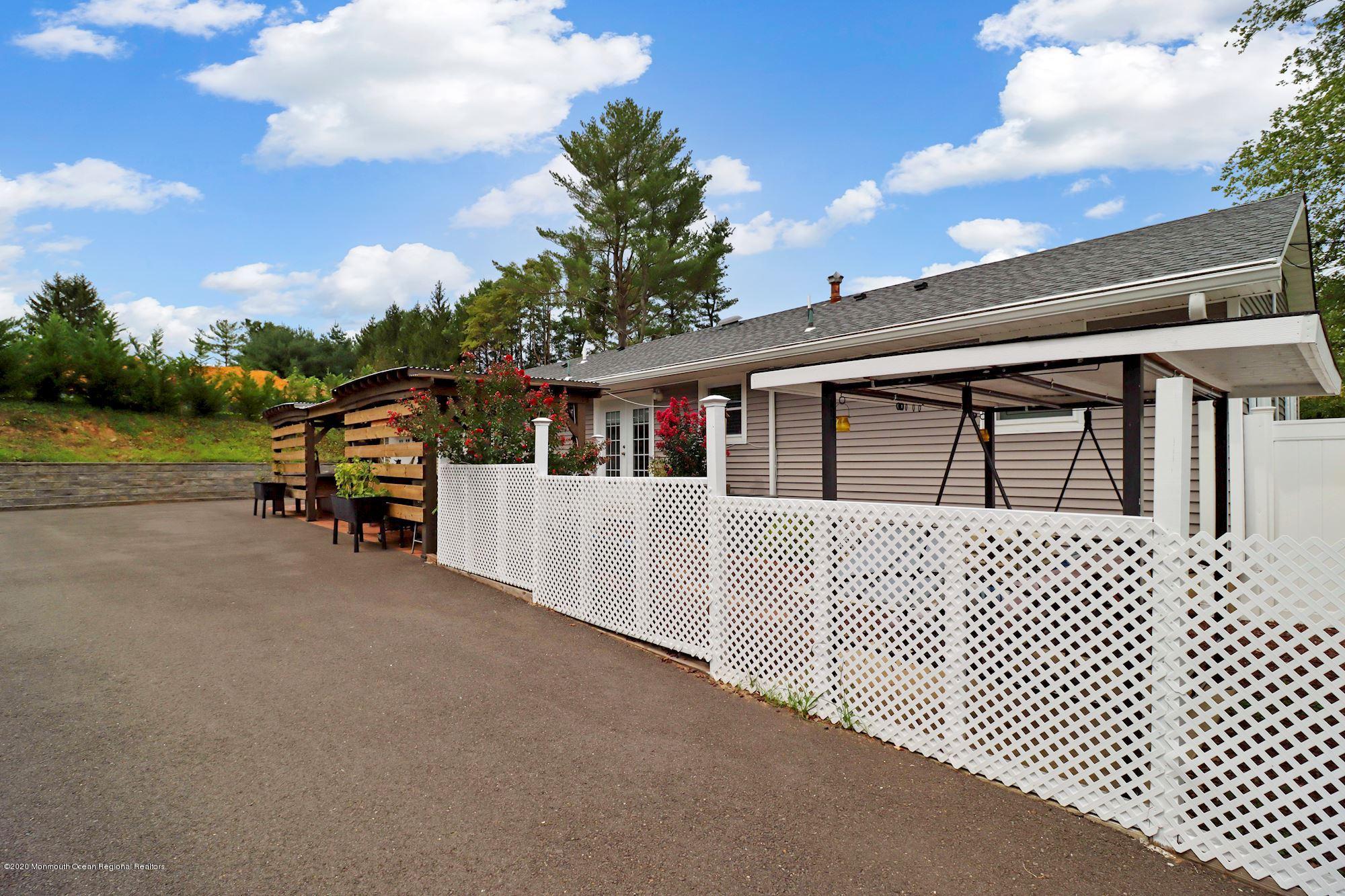 30 Wickatunk Road Manalapan, NJ 07726 - Photo 26 of 31 a front view of a house with a yard