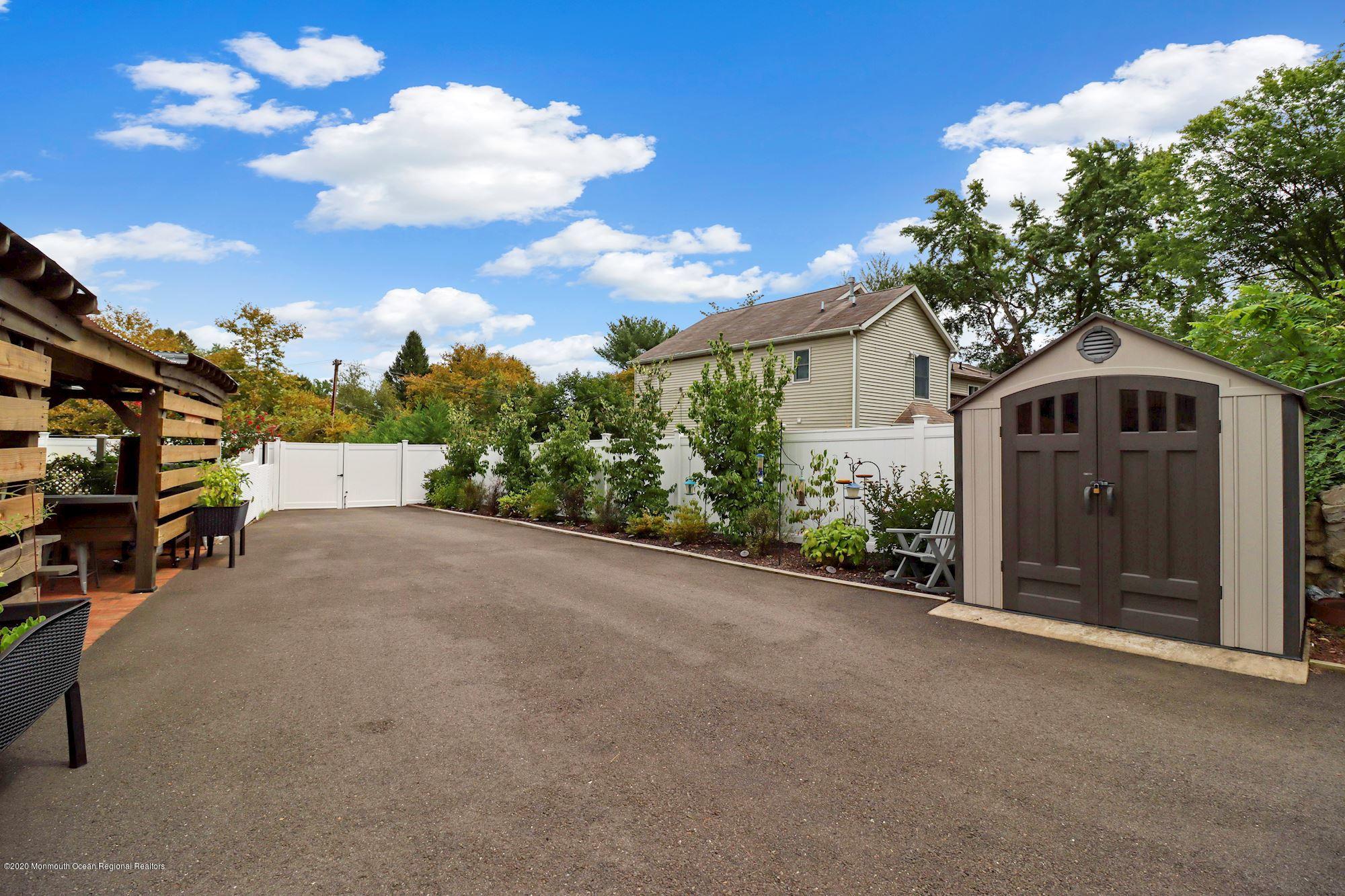30 Wickatunk Road Manalapan, NJ 07726 - Photo 27 of 31 a view of a house with a yard and garage