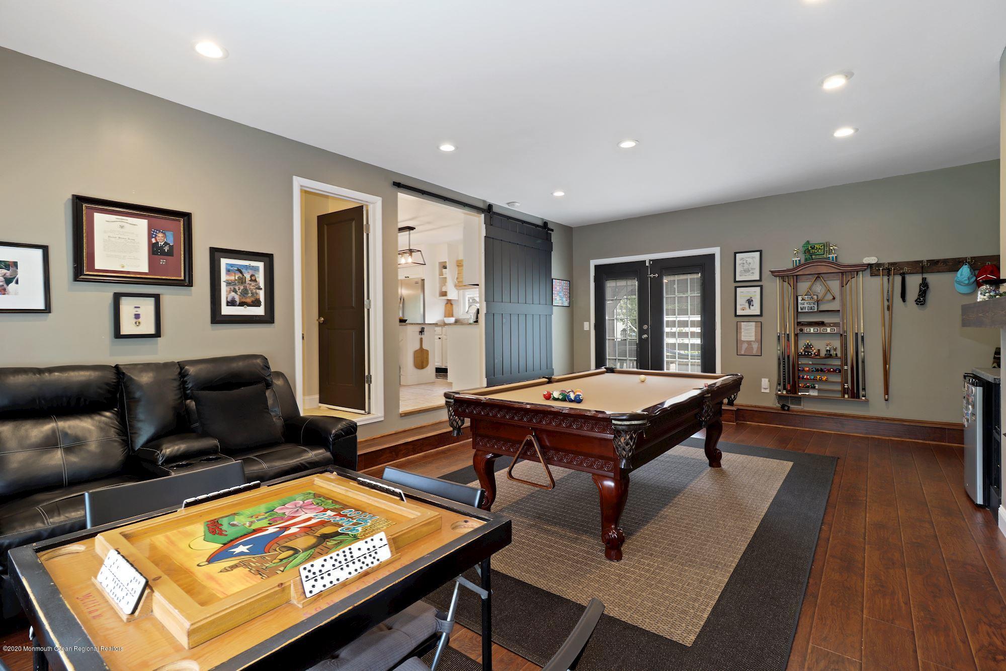 30 Wickatunk Road Manalapan, NJ 07726 - Photo 3 of 31 a living room with furniture pool table and a flat screen tv