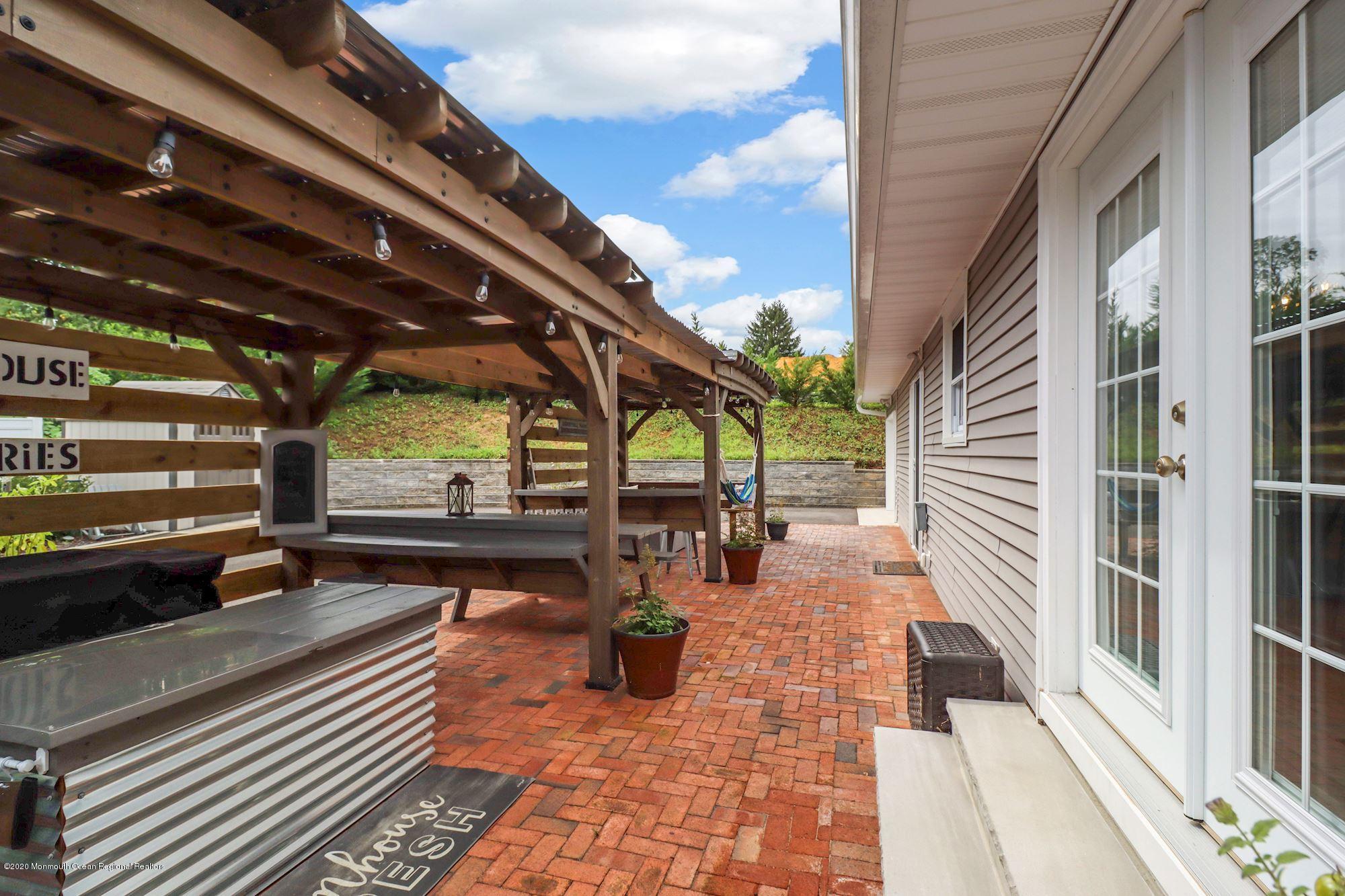 30 Wickatunk Road Manalapan, NJ 07726 - Photo 31 of 31 a view of a patio with a table and chairs