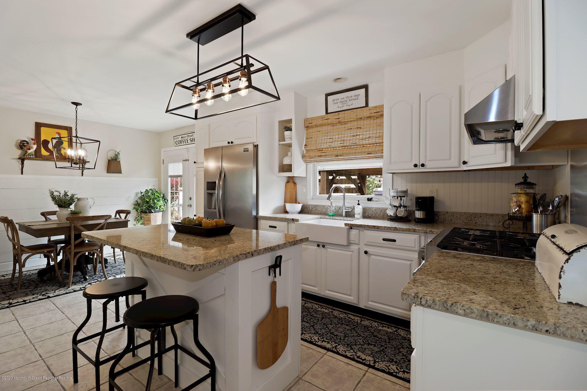 30 Wickatunk Road Manalapan, NJ 07726 - Photo 5 of 31 a kitchen with stainless steel appliances granite countertop a sink a stove a refrigerator cabinets and chairs