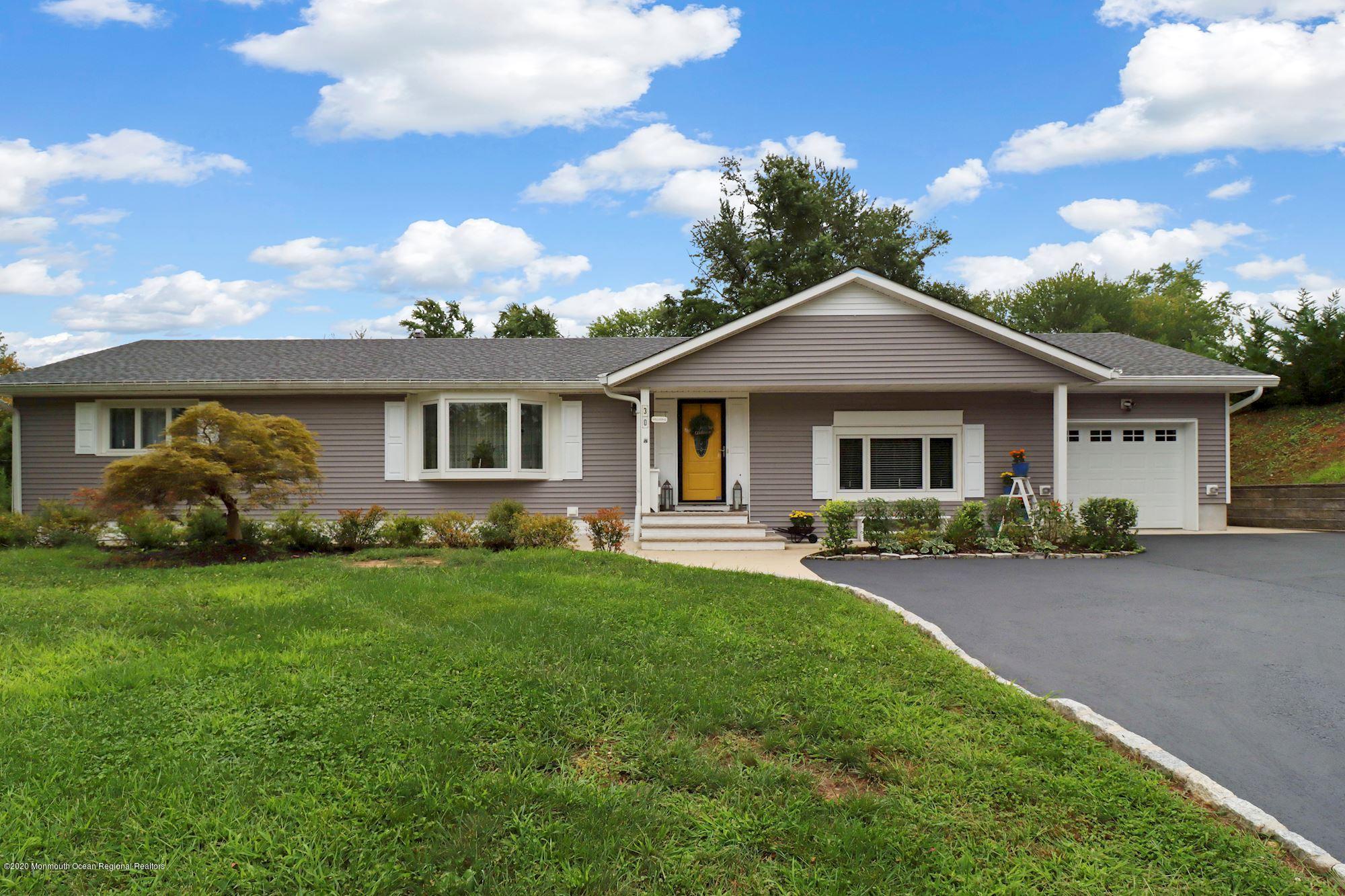 30 Wickatunk Road Manalapan, NJ 07726 - Photo 7 of 31 a front view of a house with a garden
