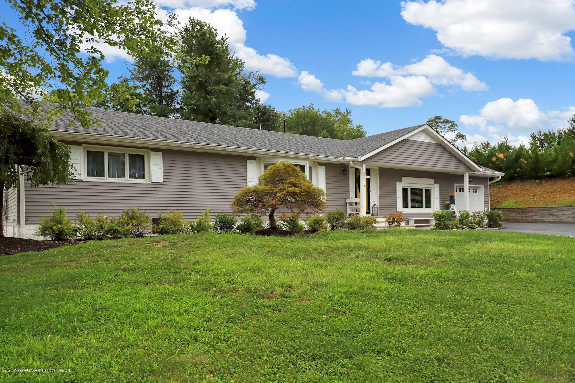 30 Wickatunk Road Manalapan, NJ 07726 - Photo 8 of 31 a front view of a house with a garden