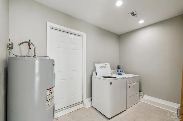 a kitchen with stainless steel appliances kitchen island hardwood floor and a sink